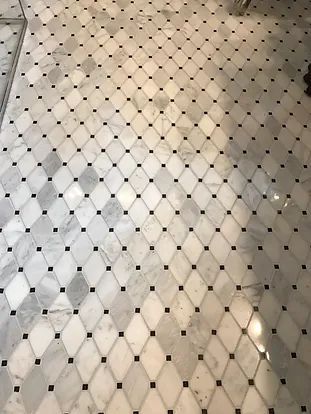 Marble tile floor with diamond pattern, alternating white, gray, and black tiles.
