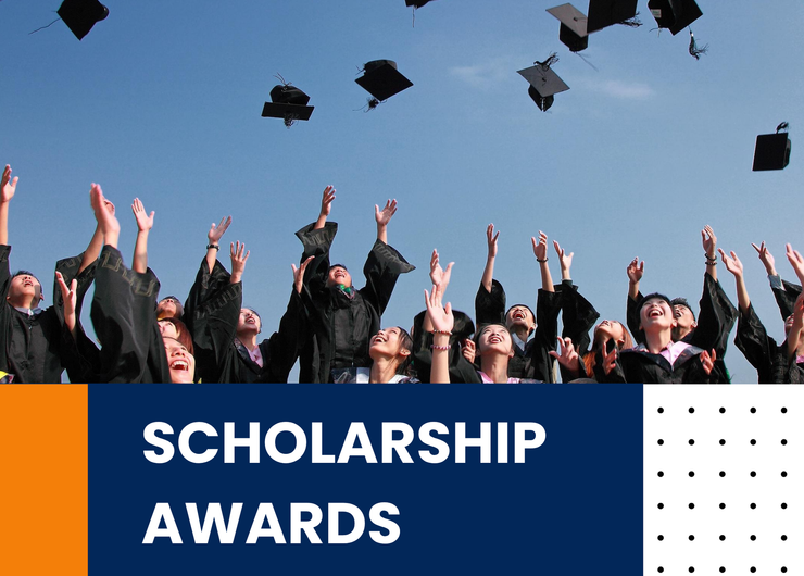 Graduates toss caps in the air above a “Scholarship Awards” banner