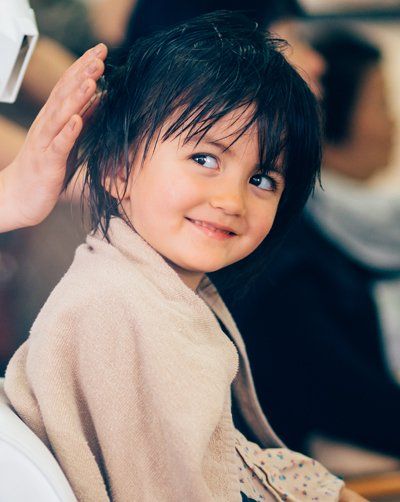 Adorable mixed race little girl at hair salon