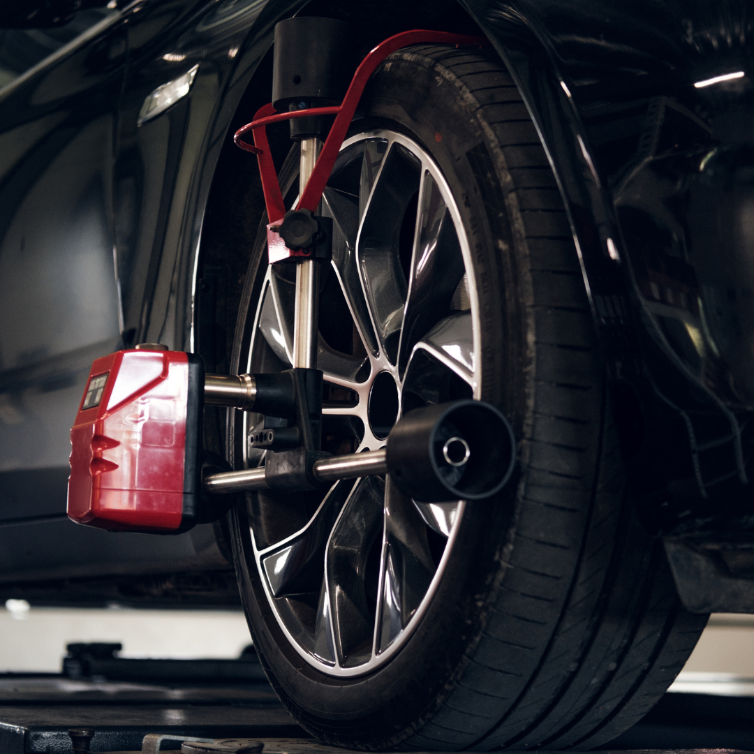 A car wheel is being adjusted by a machine | Walt's Auto Service