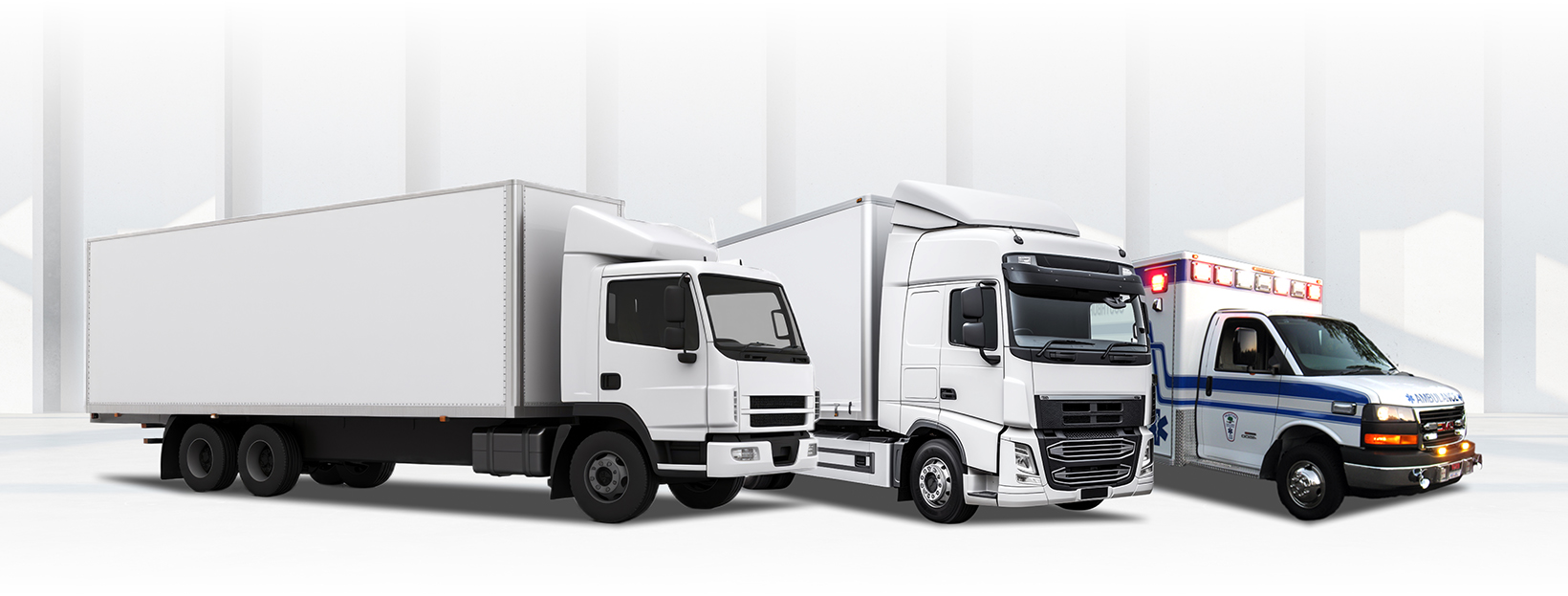 Three white trucks are parked next to each other on a white background. | Walt's Auto Service