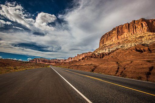 A road in the desert with a mountain in the background. | Walt's Auto Service