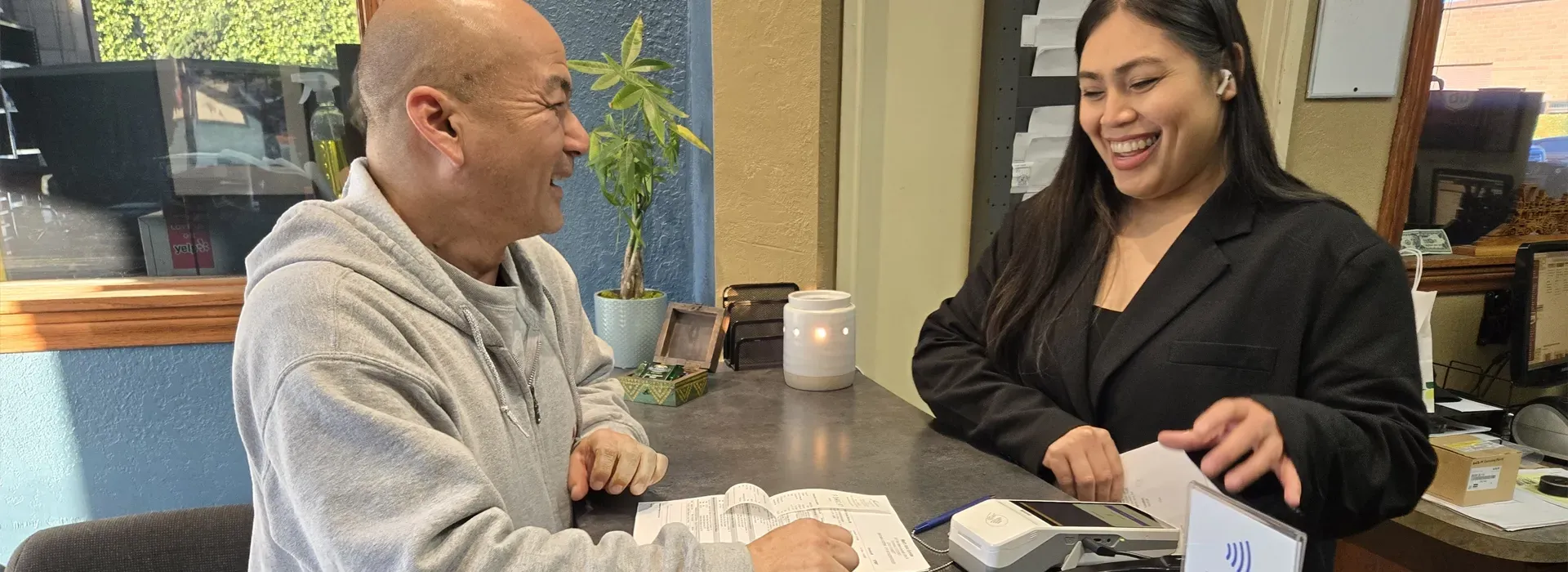 Customer at receptionist desk, ready to pay | Walt's Auto Service