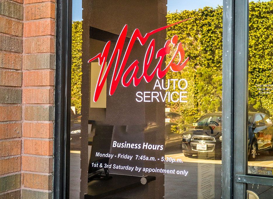 A store front with a sign that says ' walker 's auto service ' on it | Walt's Auto Service
