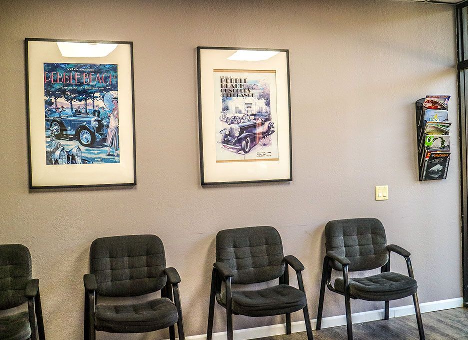 A waiting room with chairs and pictures on the wall. | Walt's Auto Service