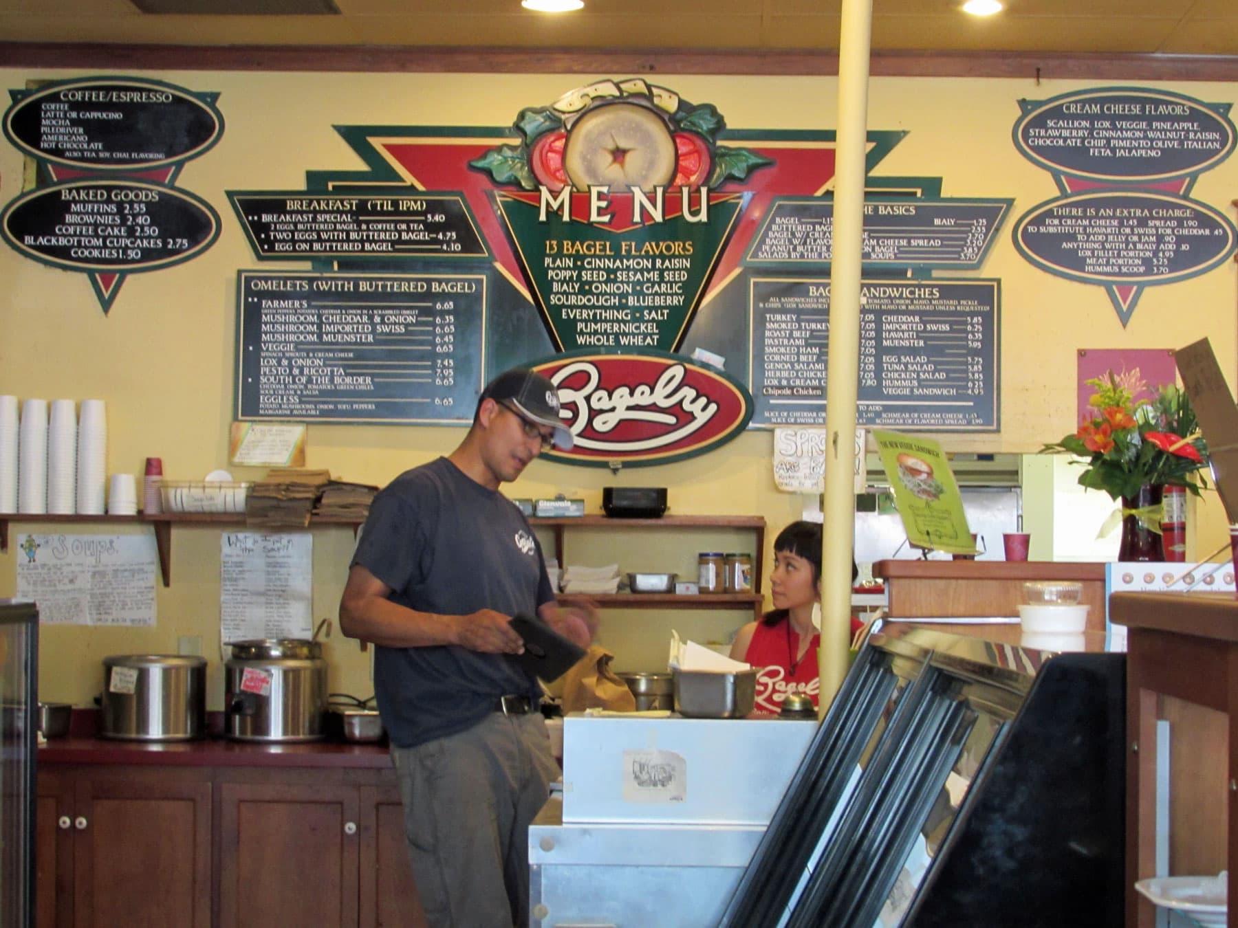 A man standing in front of a sign that says menu