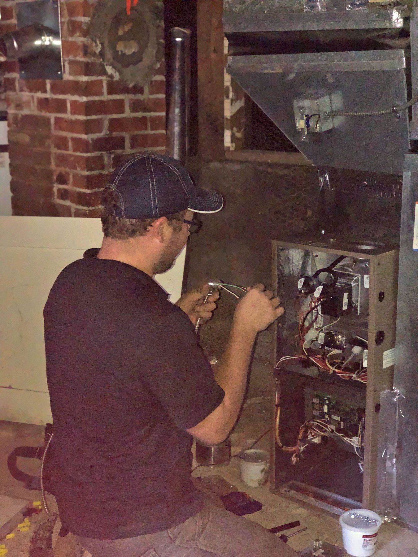 Photo of a technician installing a furnace