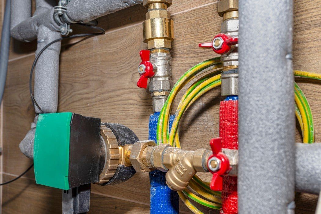 A close up of a water supply system with pipes and valves.