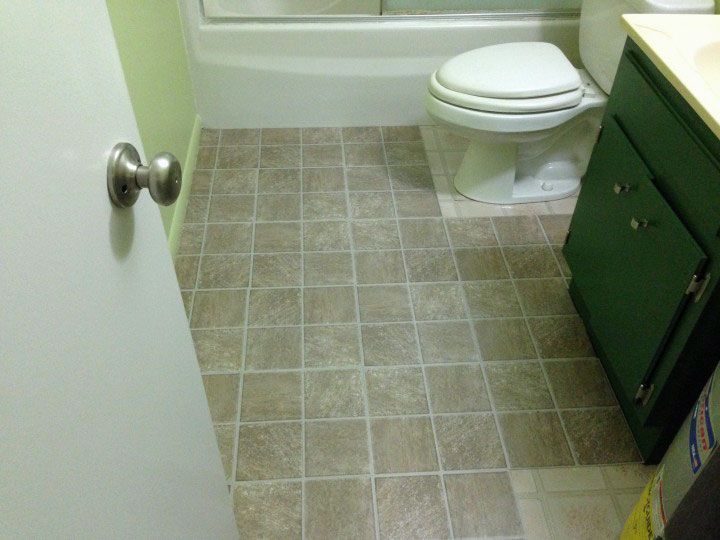 A bathroom with a toilet , sink , and bathtub.