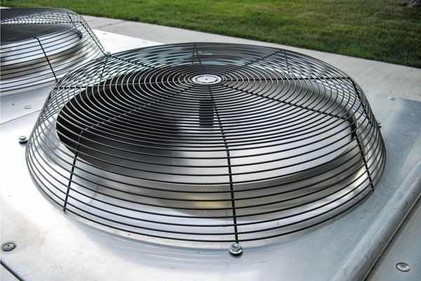 A close up of a fan on top of a building