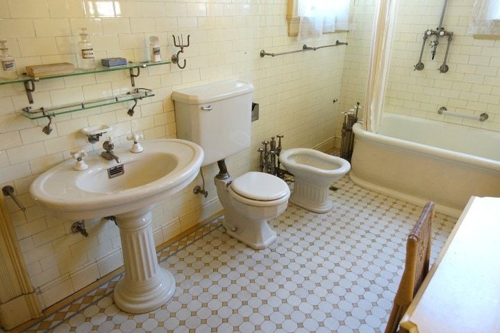 A bathroom with a sink , toilet , bidet and bathtub.