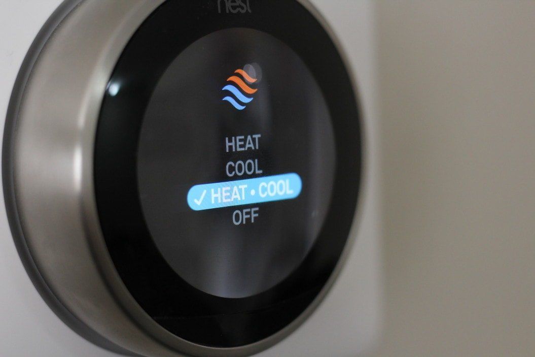 A smart thermostat that says heat cool and off