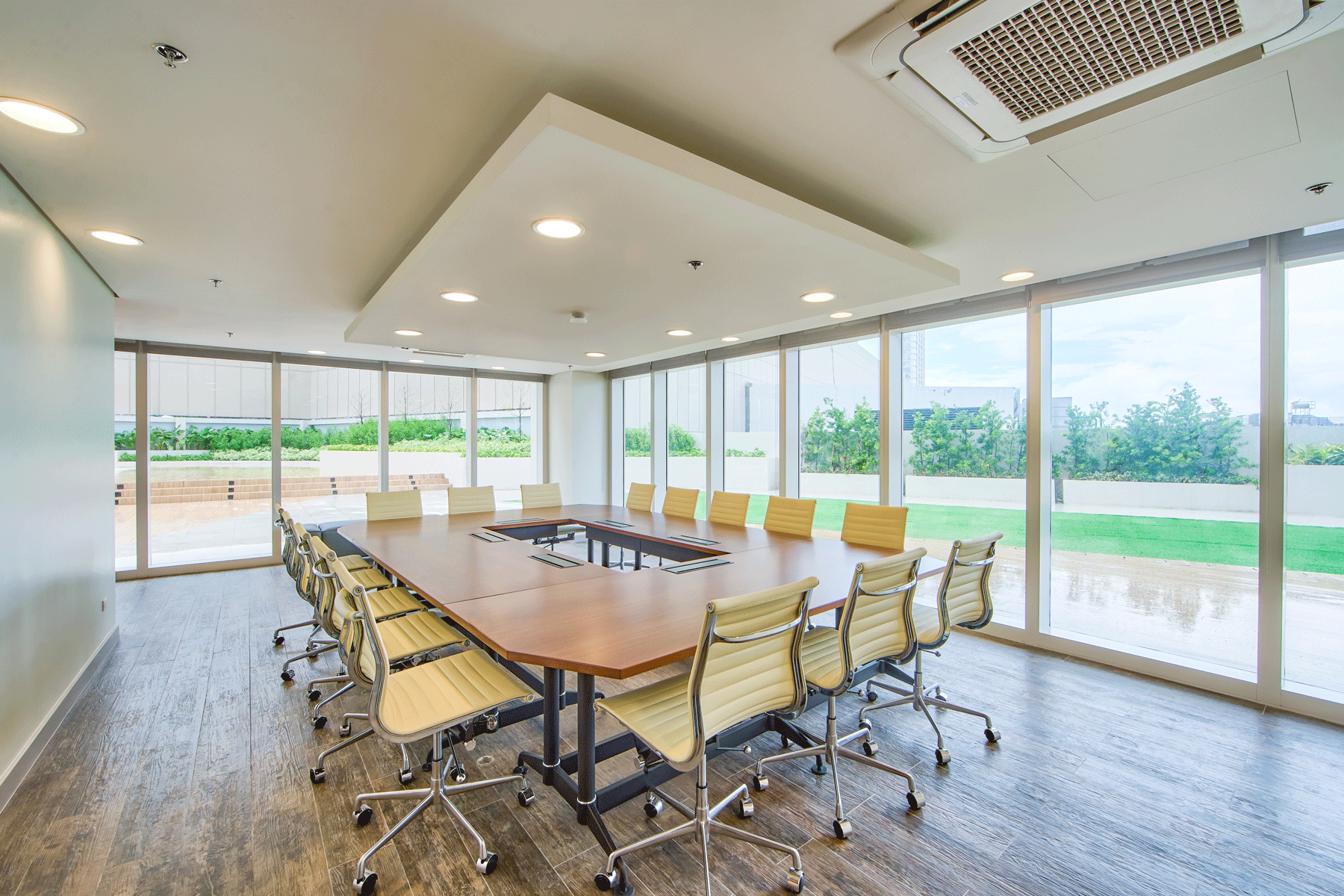 A large conference room with a long table and chairs.