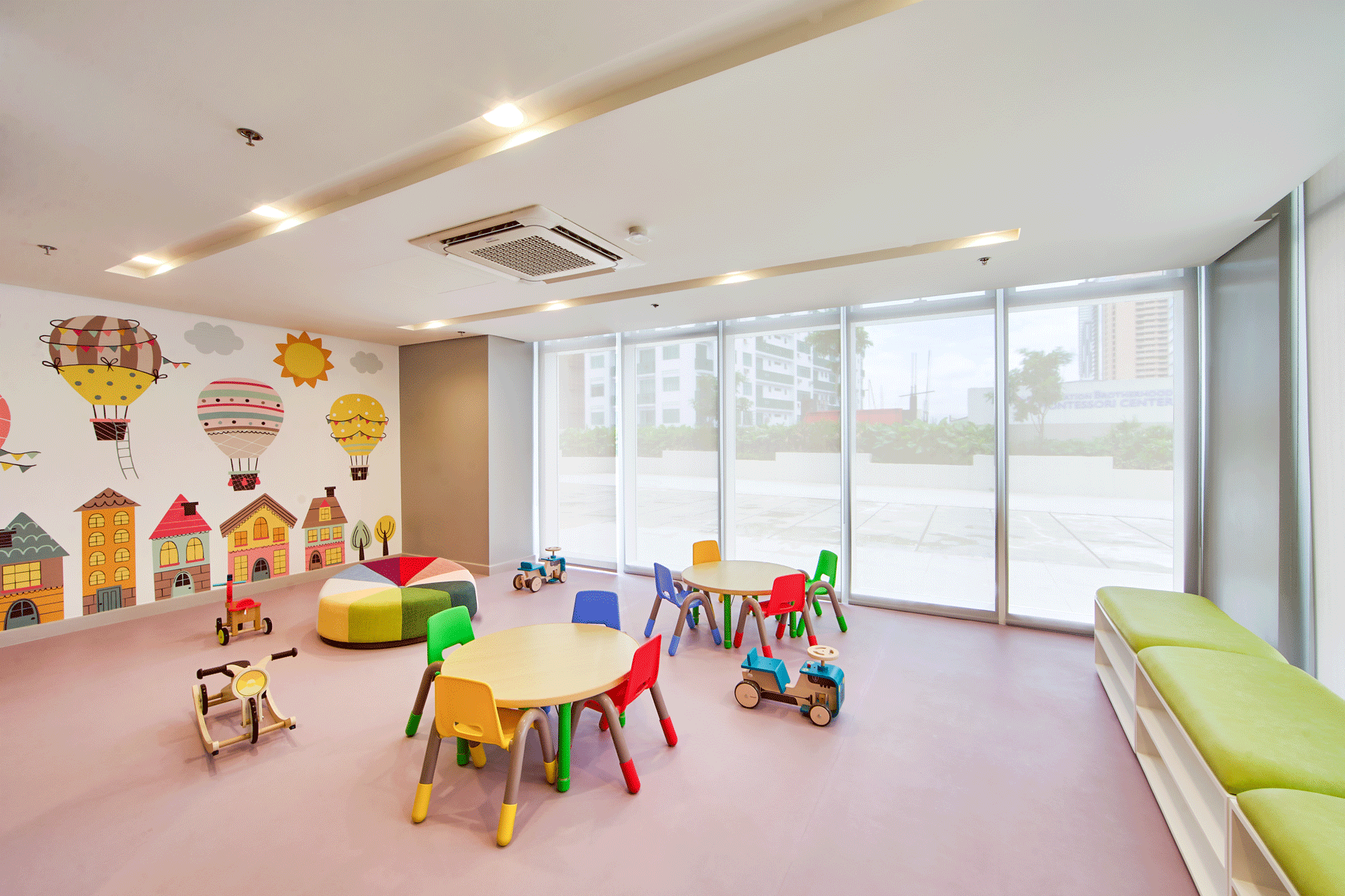 A children 's room with tables , chairs , and toys.