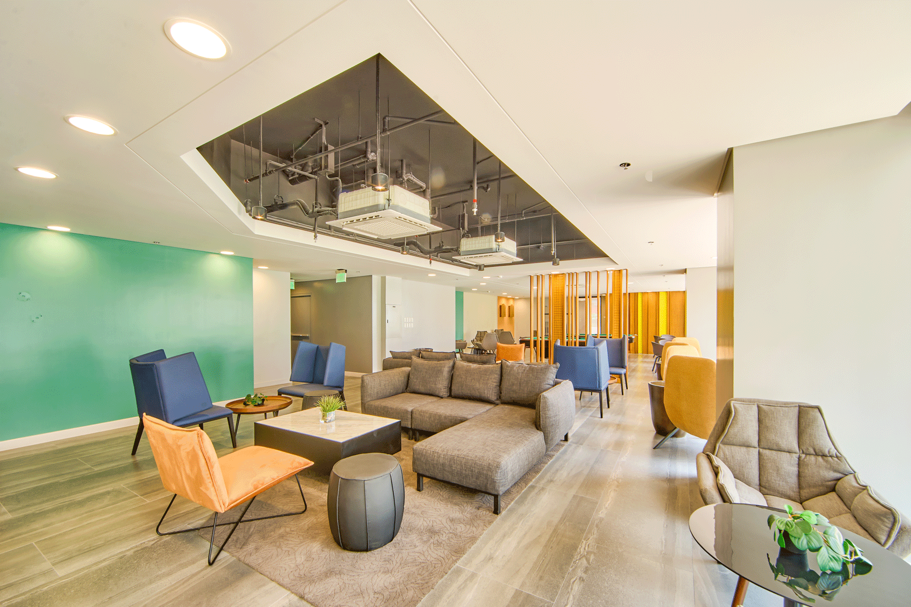 Modern lounge area at Connor Serviced Residences near Greenhills featuring contemporary furniture and mint accent walls