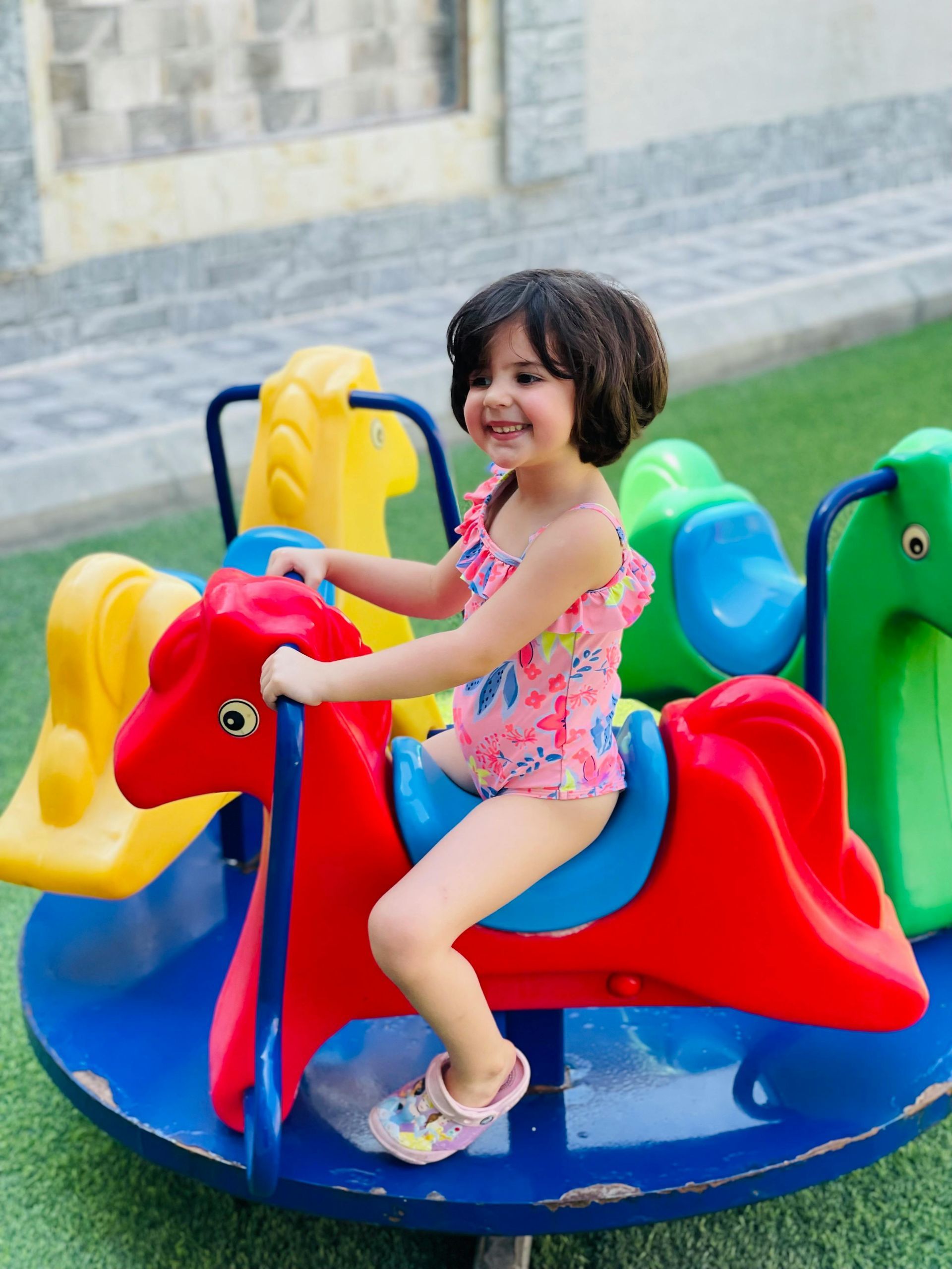 Child enjoying colorful playground equipment at Connor Serviced Residences near Greenhills, perfect for family staycations