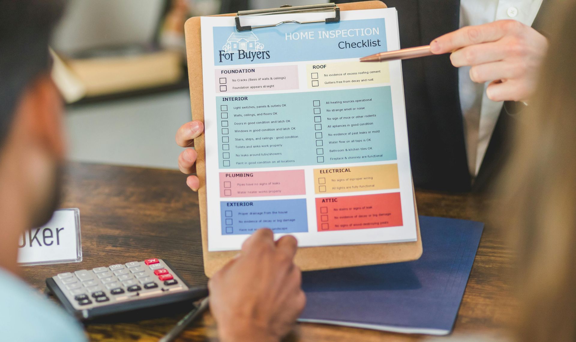 A man is holding a clipboard with a home inspection checklist.