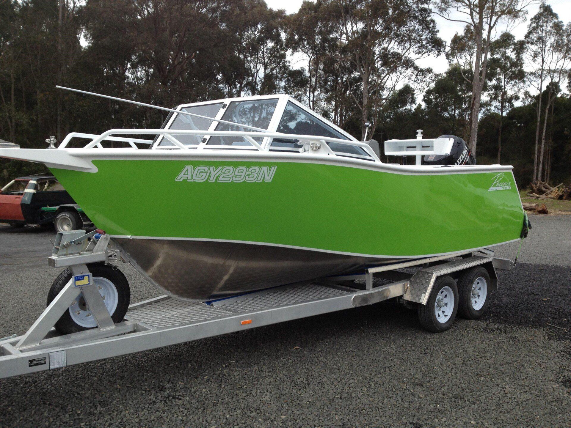 green runabout boat on top of trailer