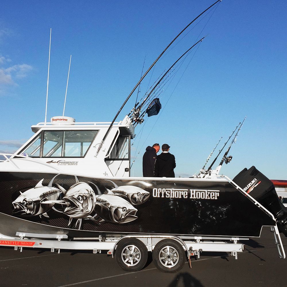 boat named Offshore Hooker on top of trailer