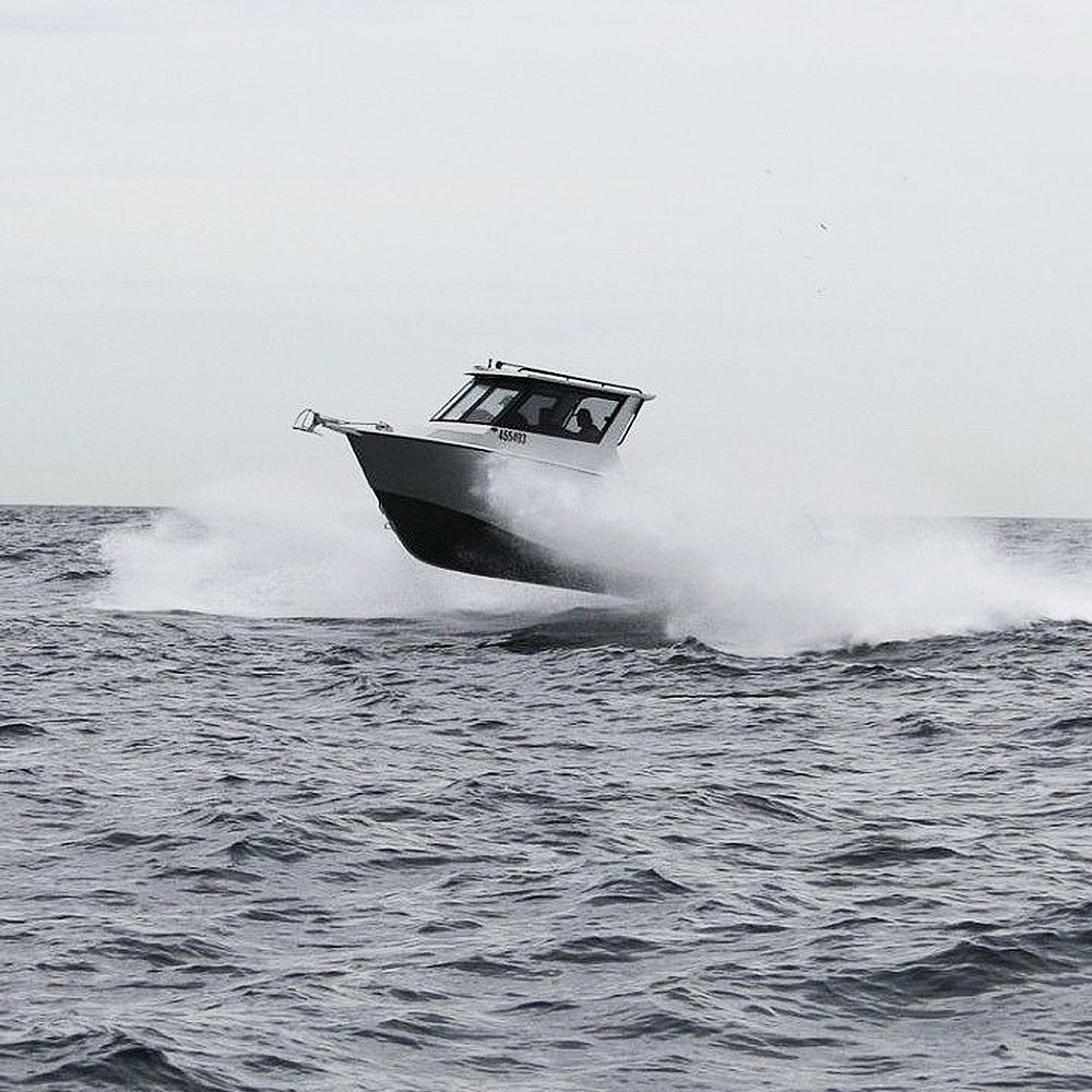 A black and white photo of a boat in the ocean