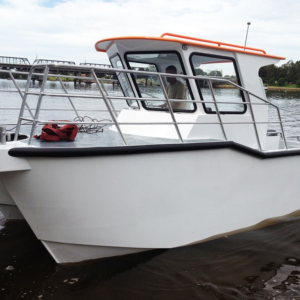 A white catamaran with an orange roof is in the water