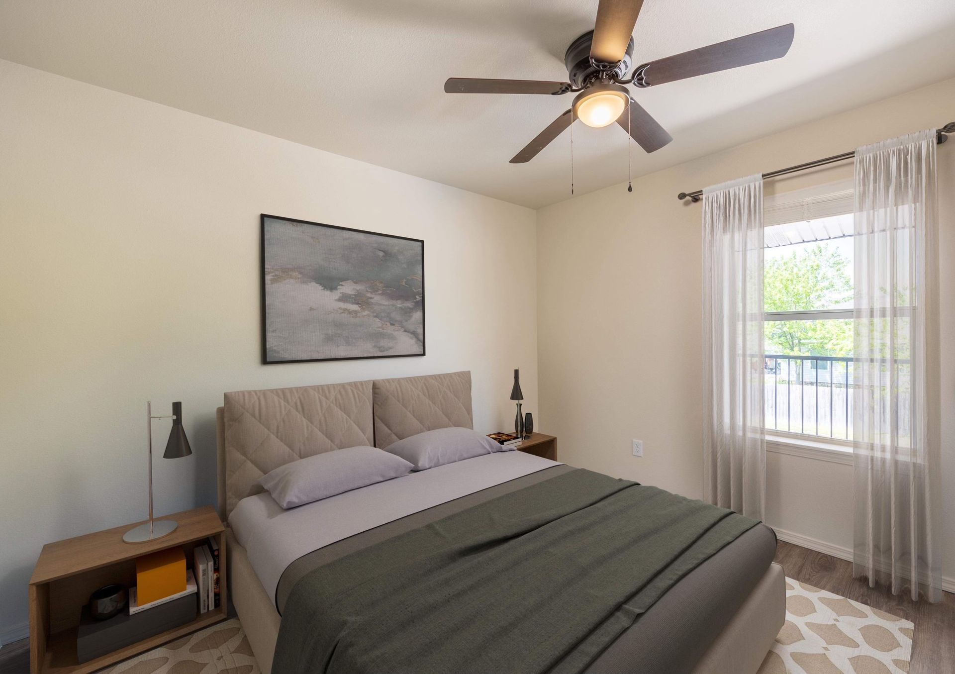 A bedroom with a bed and a ceiling fan.
