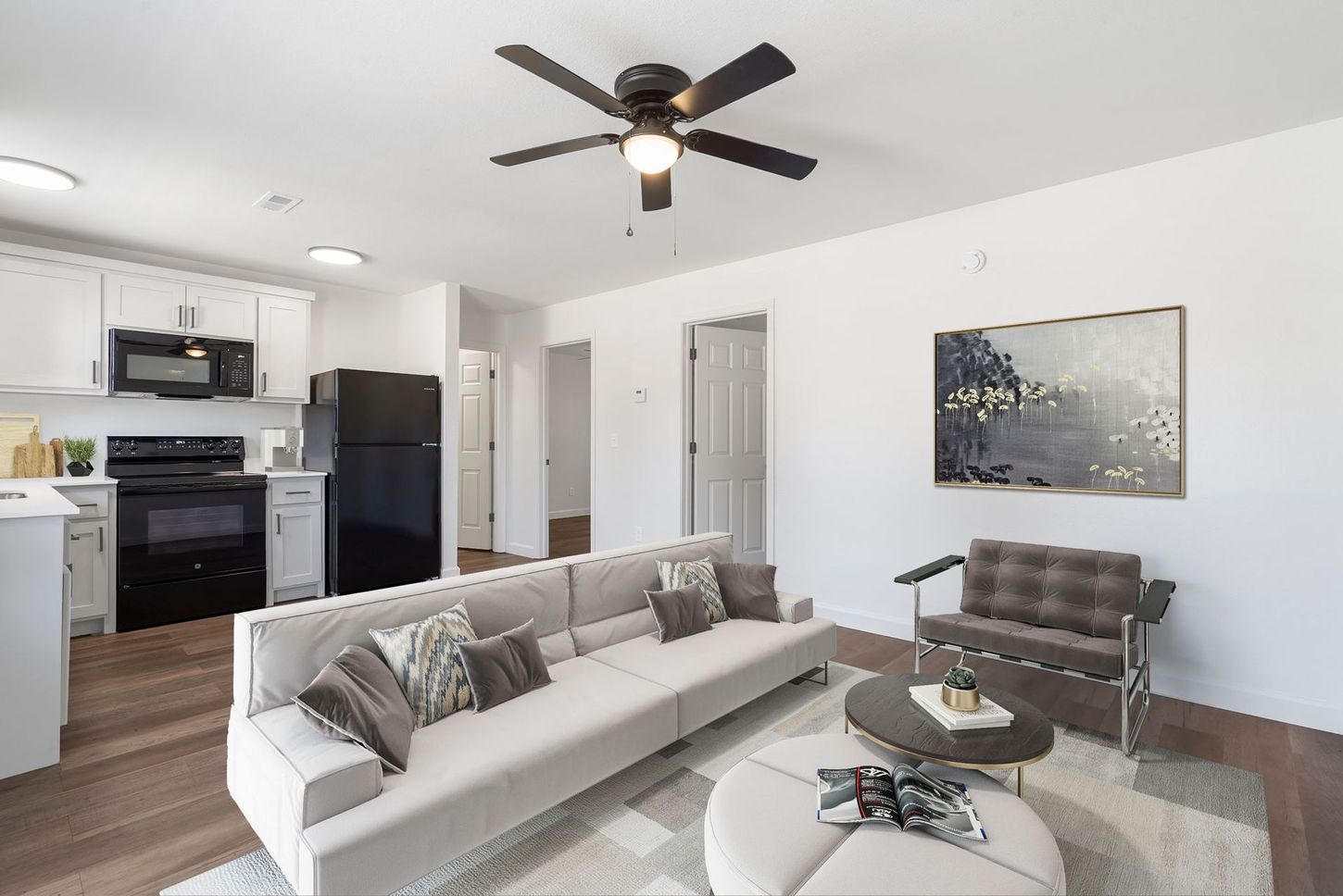 A living room with a couch and a ceiling fan