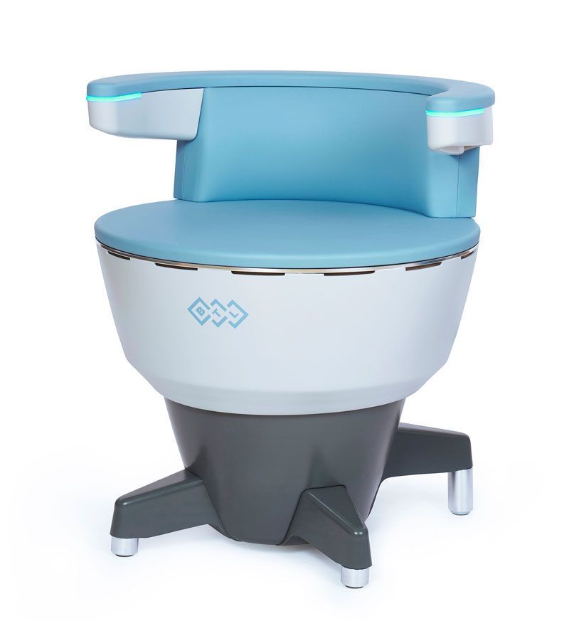 White recliner chair in a bright room with plants, next to a window with sunlight.