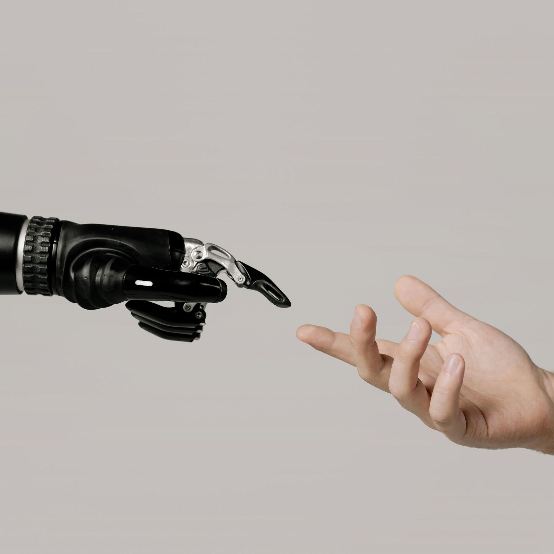 A robotic hand is reaching out to a human hand.