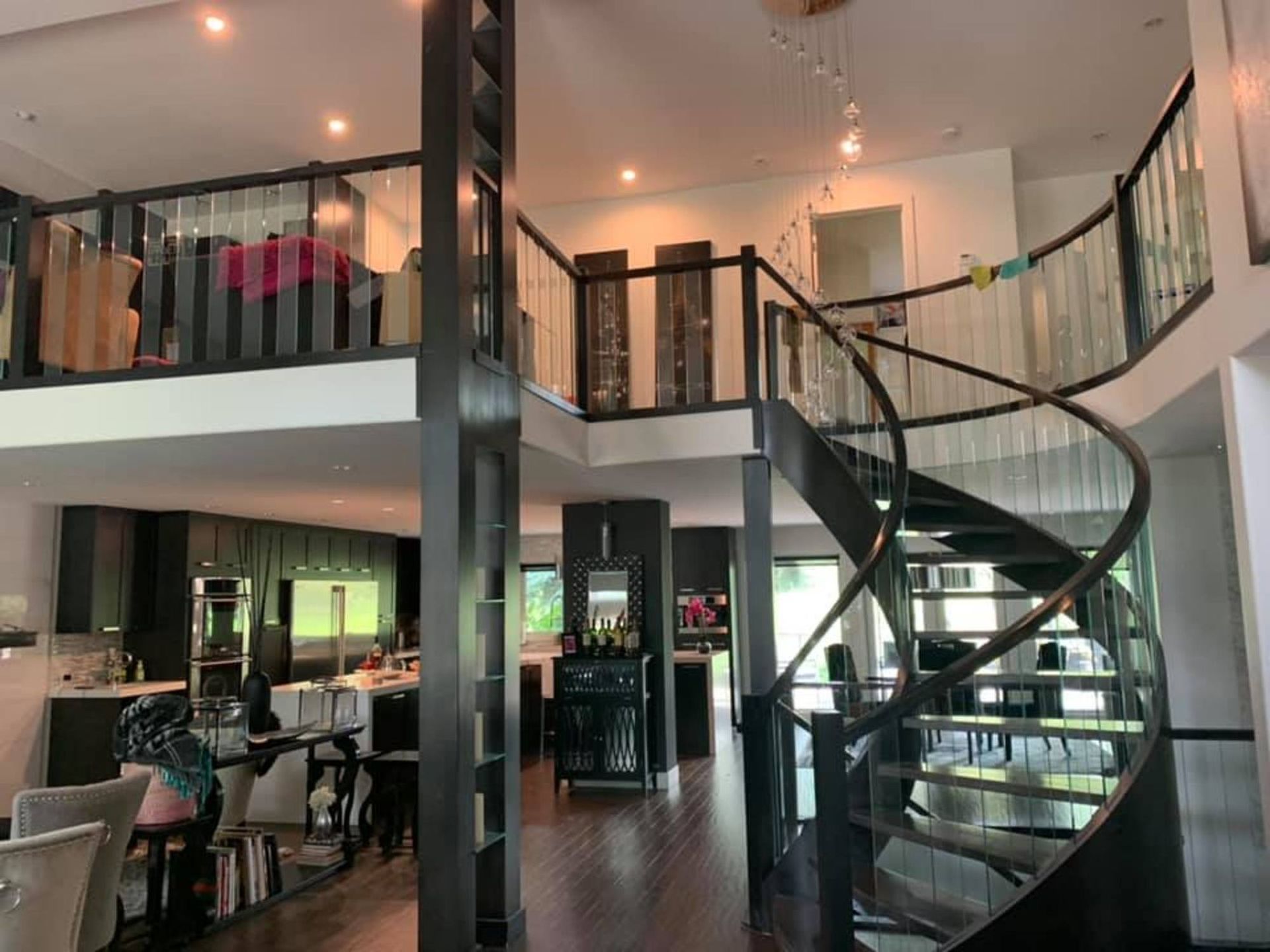 Clean and polished high-end residential interior with spiral staircase