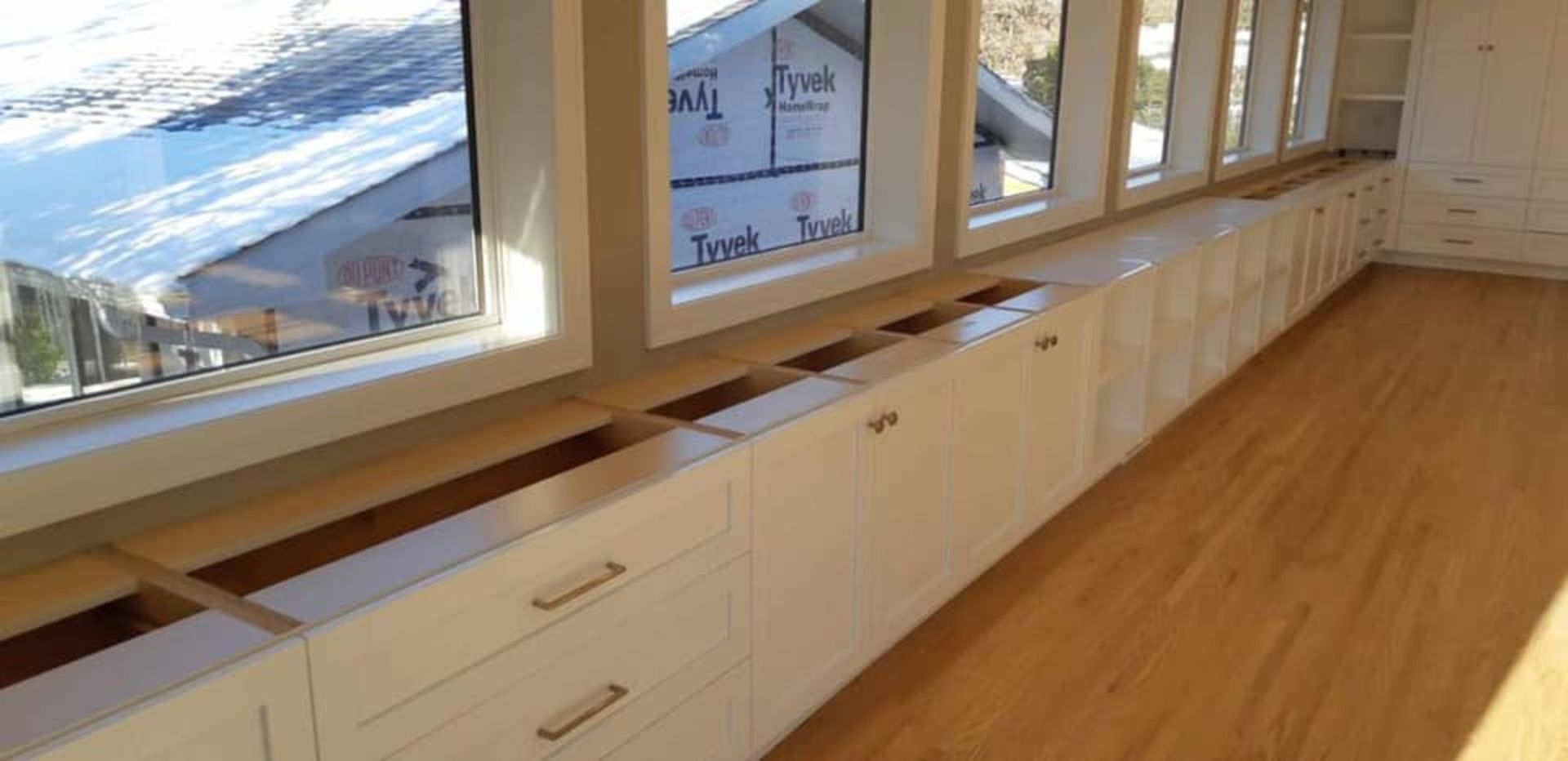 Cleaned residential space featuring custom white cabinets and natural lighting