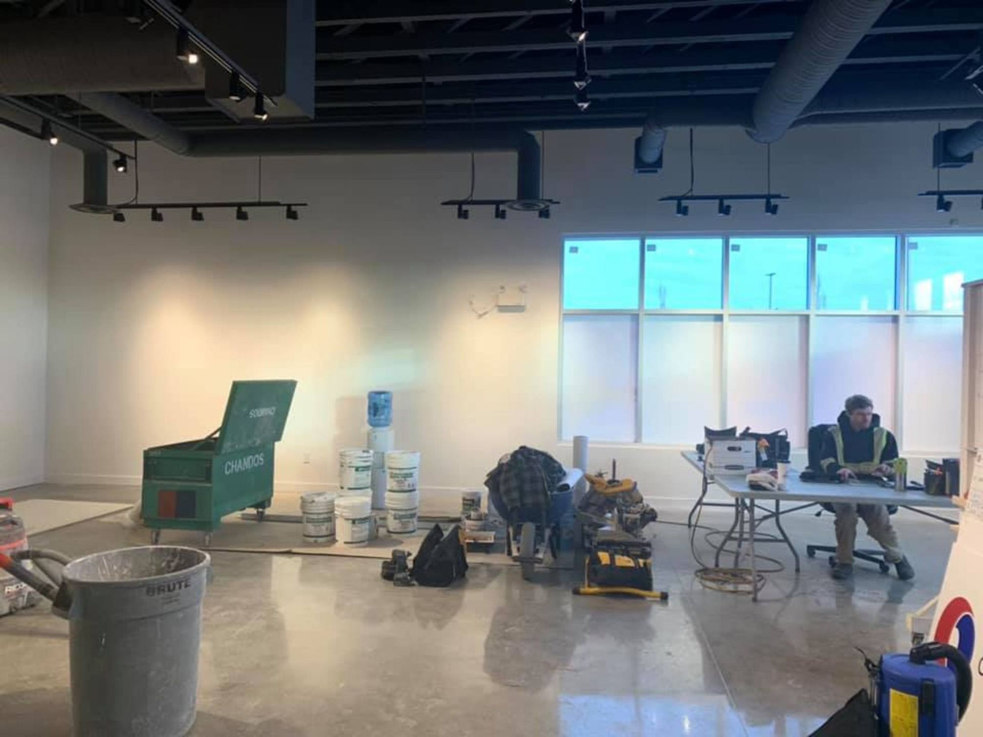 Ongoing post-renovation cleaning with tools and supplies in a commercial interior