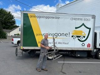 A man is standing in front of a moving truck.