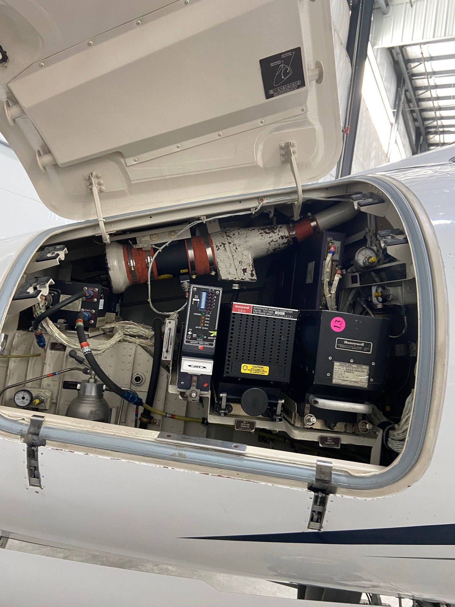 The engine of an airplane is shown with the hood open.