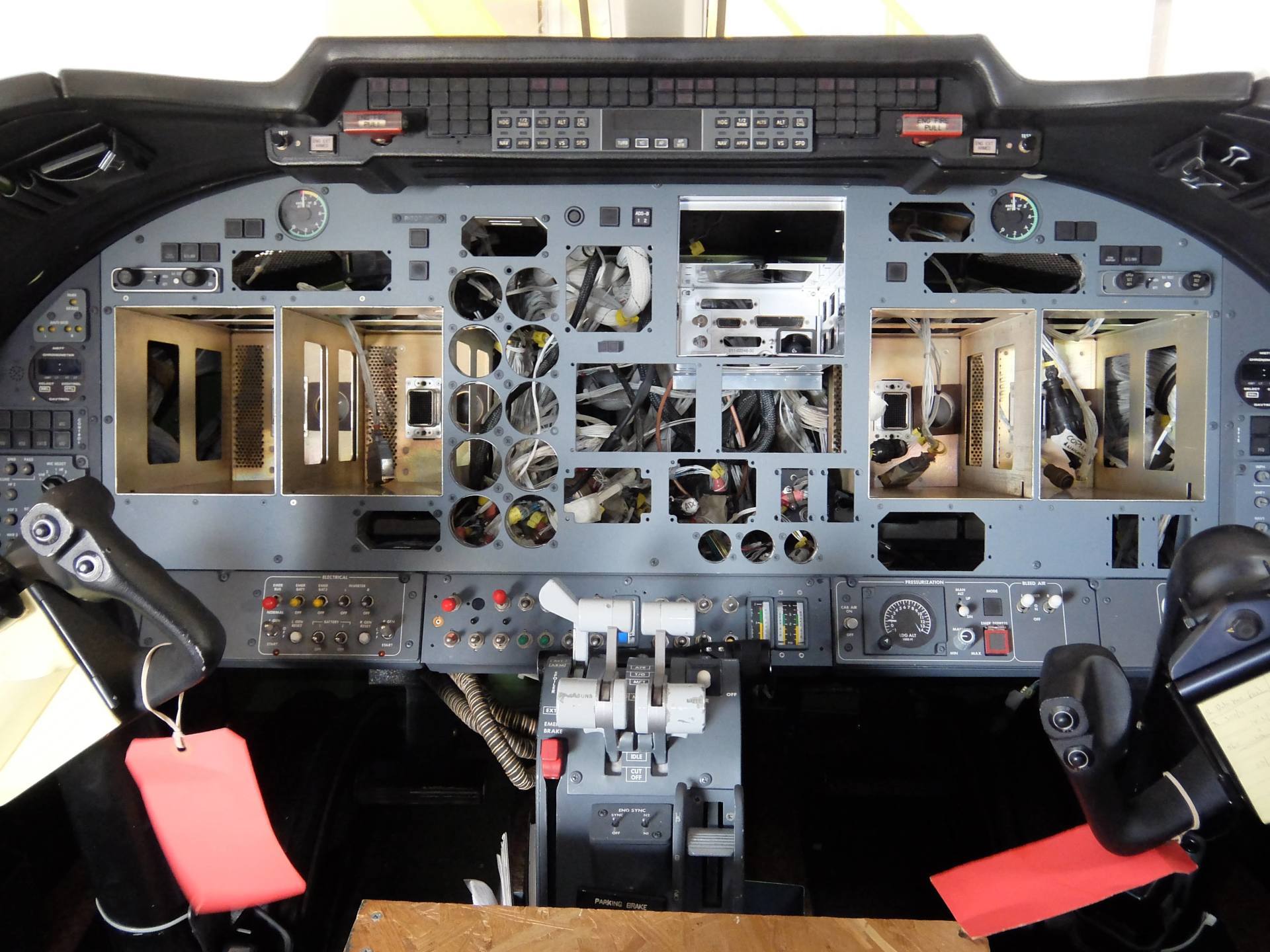 A cockpit of an airplane with a red tag on it
