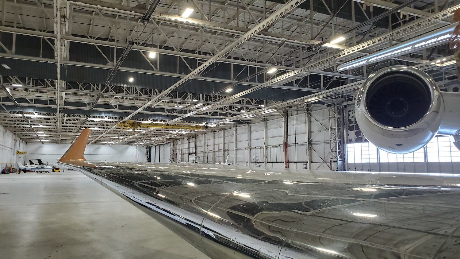 An airplane is sitting inside of a large hangar.