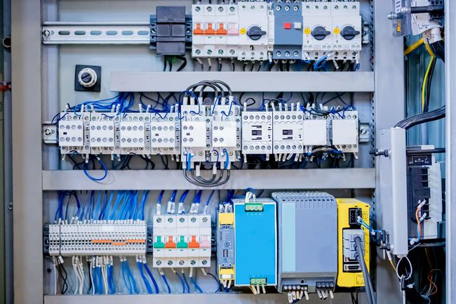 Electrical control panel with wires and components.