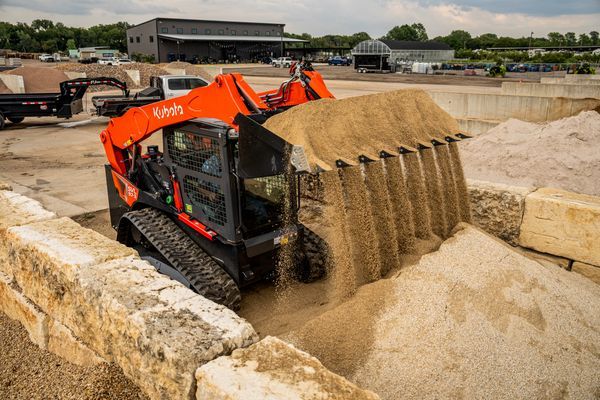A man is using a lawn mower to cut the grass in a field.