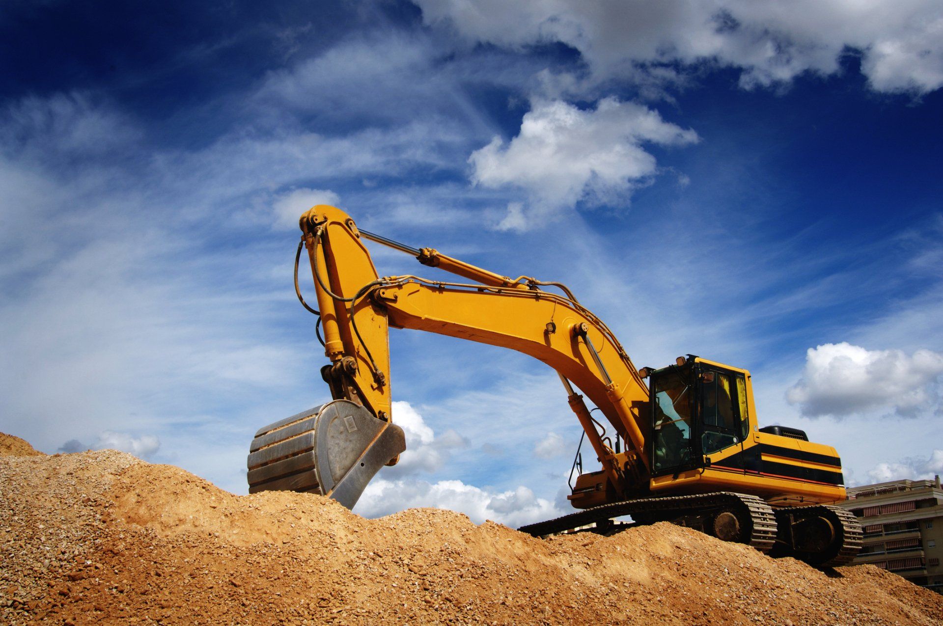 Excavator in blue sky | Birch Run, MI | Duane Jones Excavating