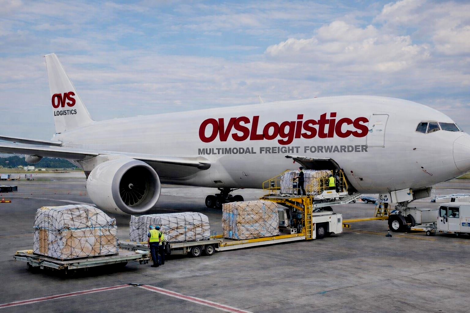 Lufthansa Airbus A380 airplane parked at an airport gate under a cloudy sky.