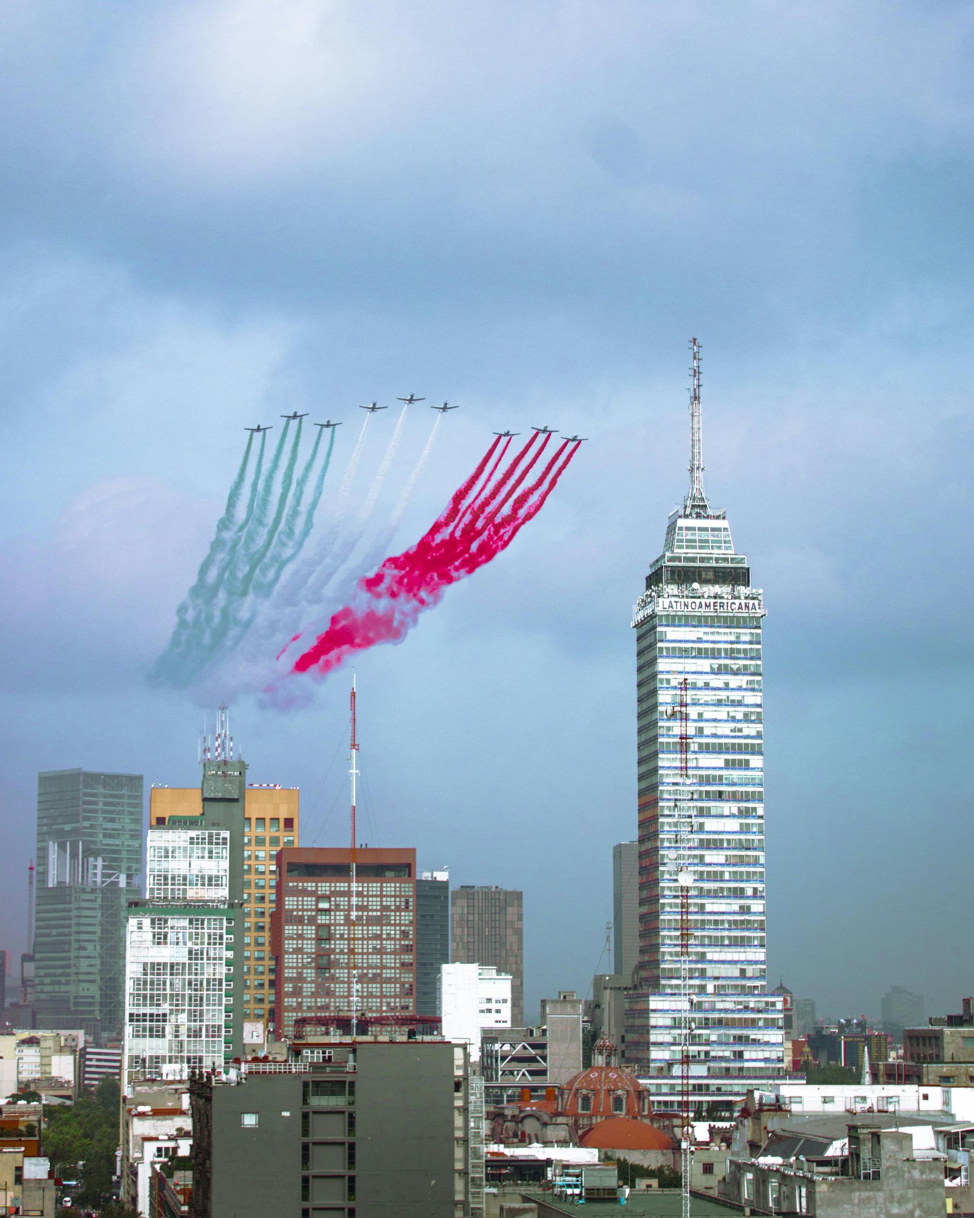 White OVS Logistics cargo plane on tarmac, under blue sky.