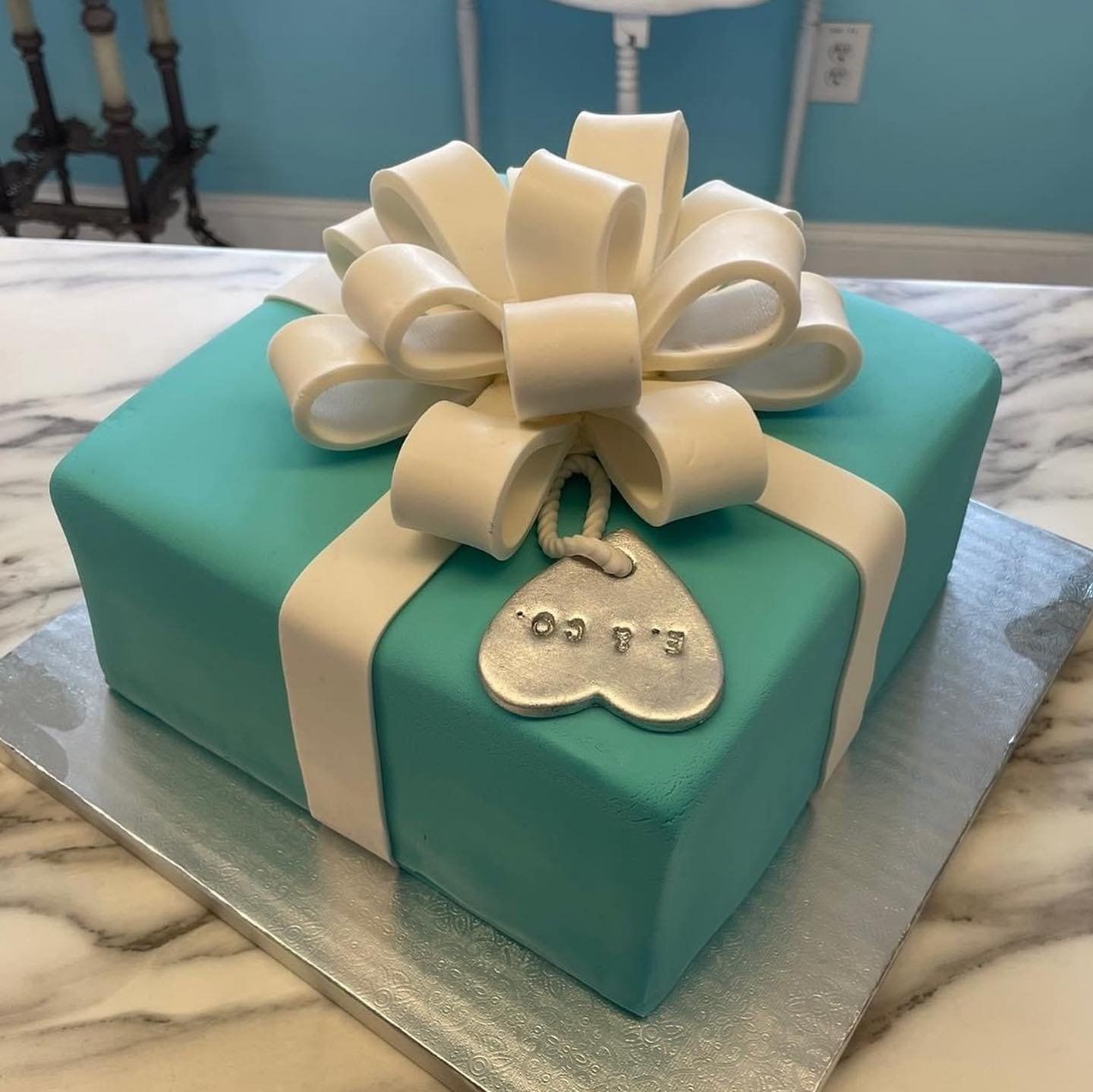 A cake in the shape of a gift box with a bow