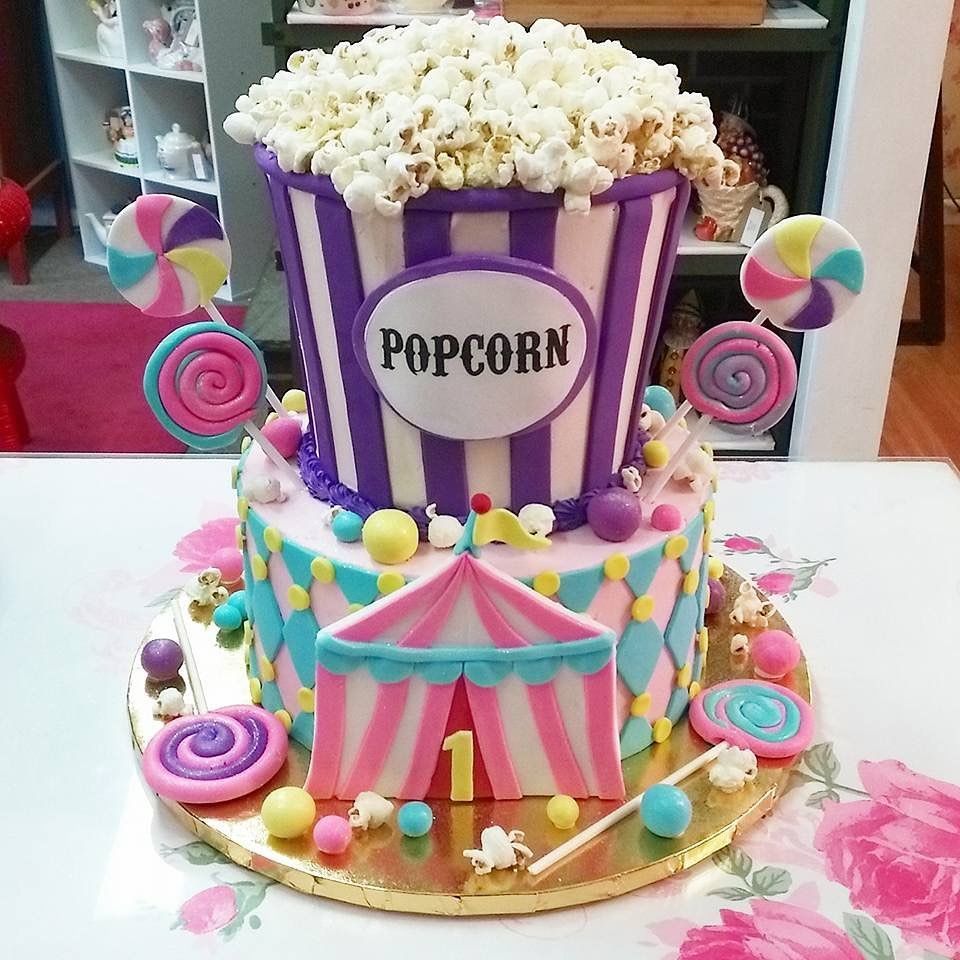A cake with a bucket of popcorn on top of it