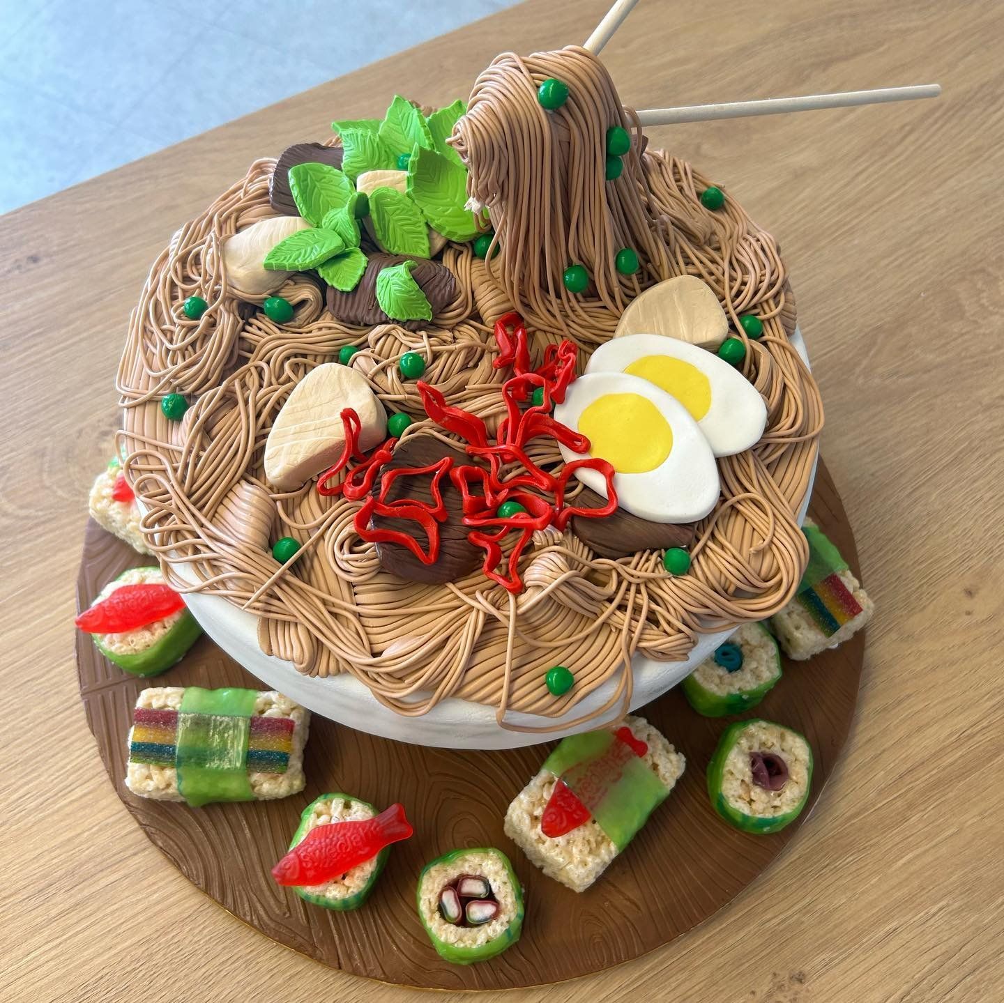 A cake that looks like a bowl of noodles and eggs