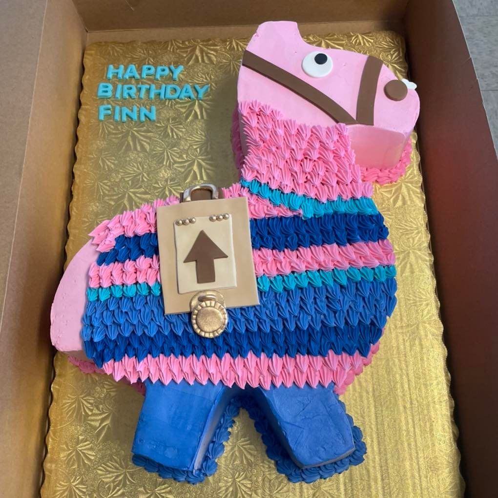 A birthday cake in the shape of a llama