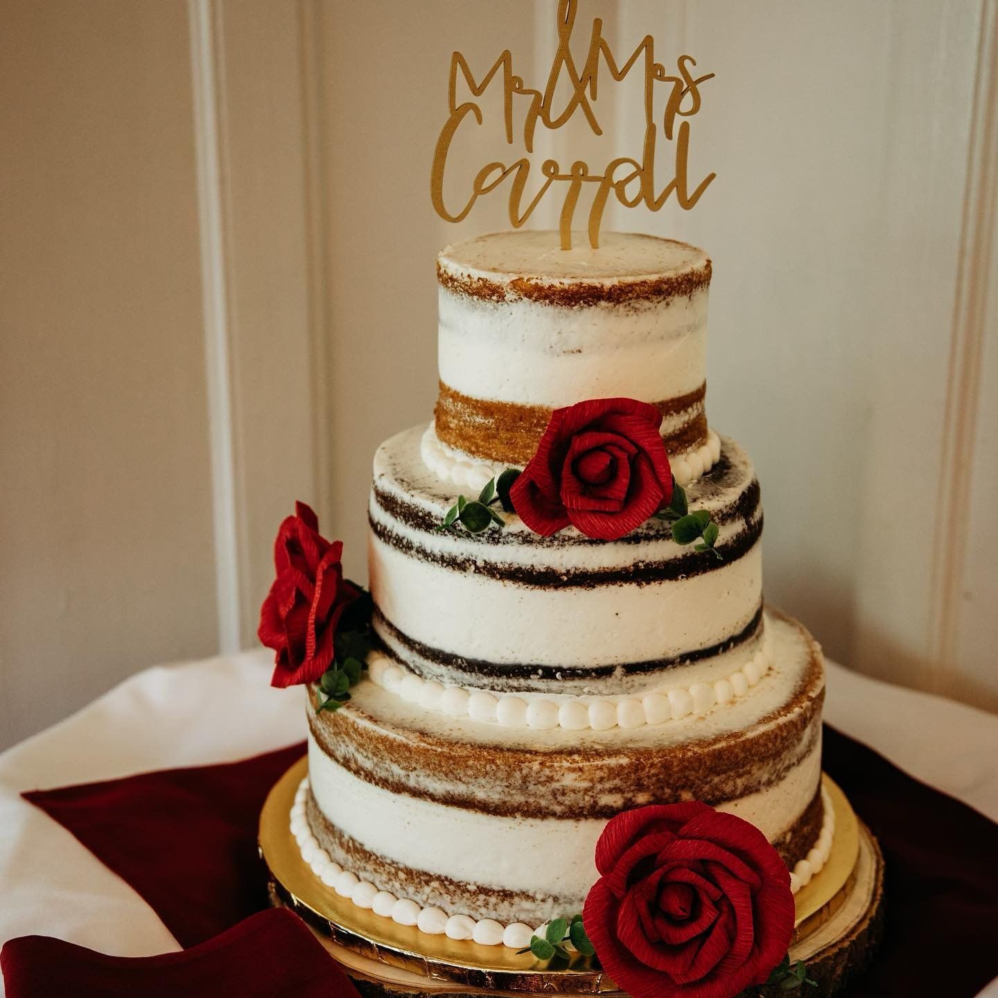 A wedding cake with a topper that says mr. and mrs. carroll