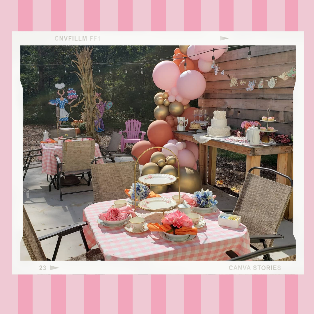 A table with a checkered tablecloth and balloons on it.