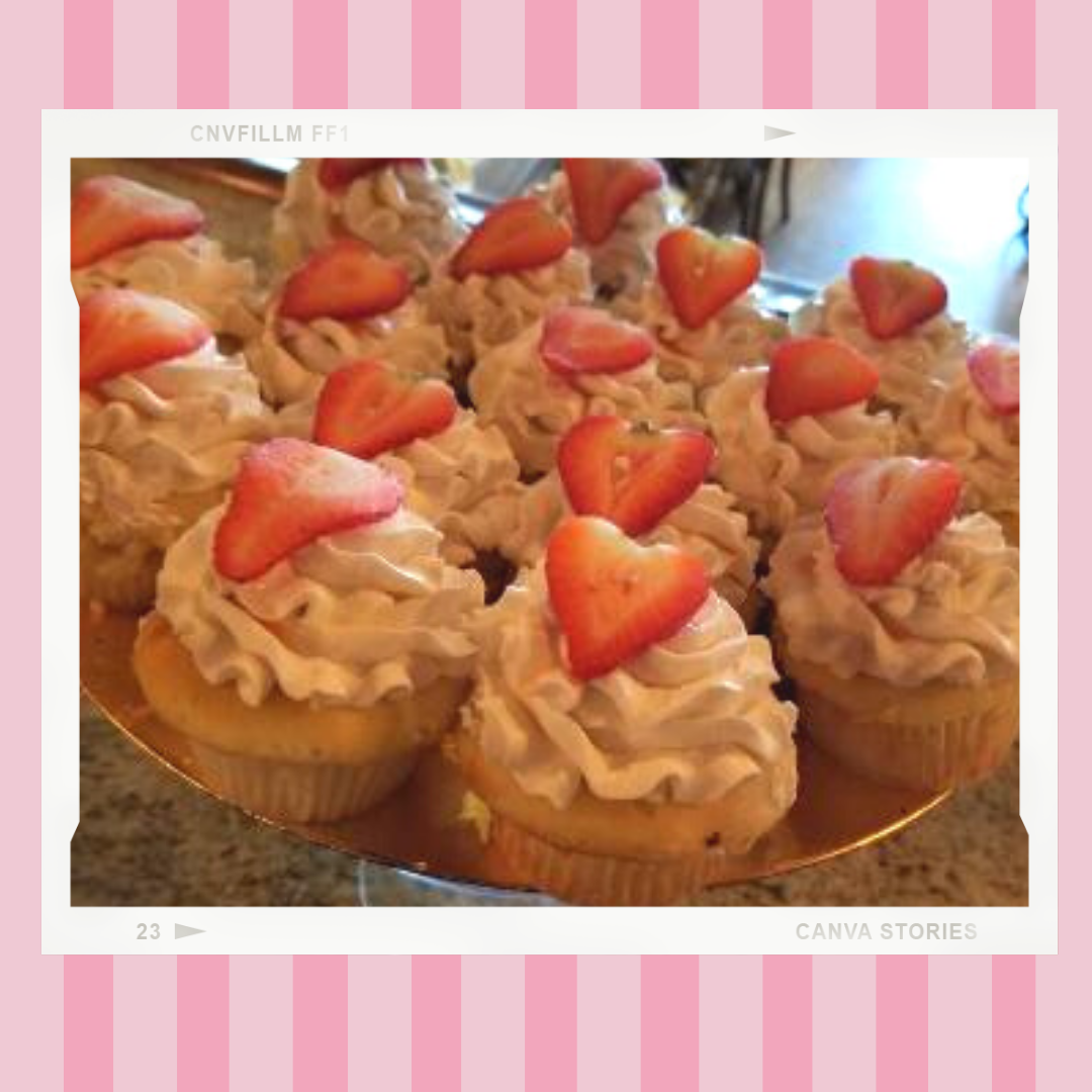 A bunch of cupcakes with whipped cream and strawberries on top