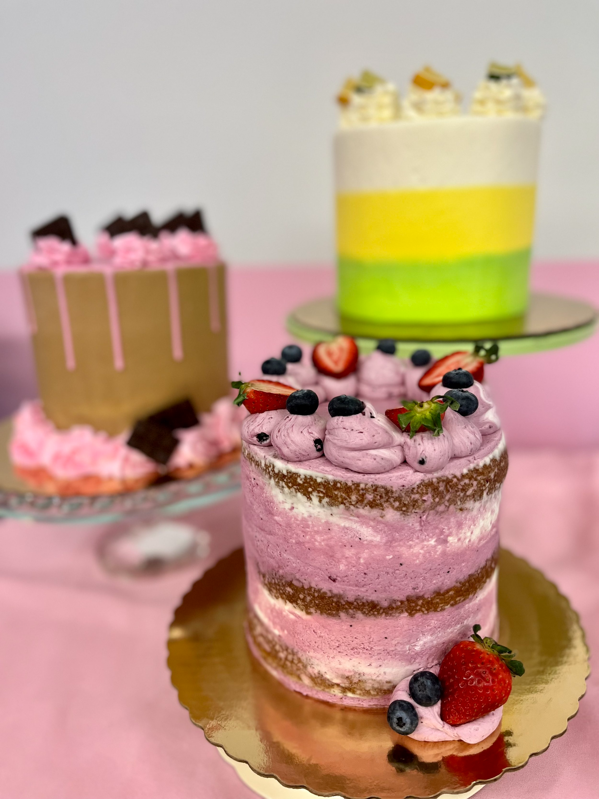 Three cakes are stacked on top of each other on a table.