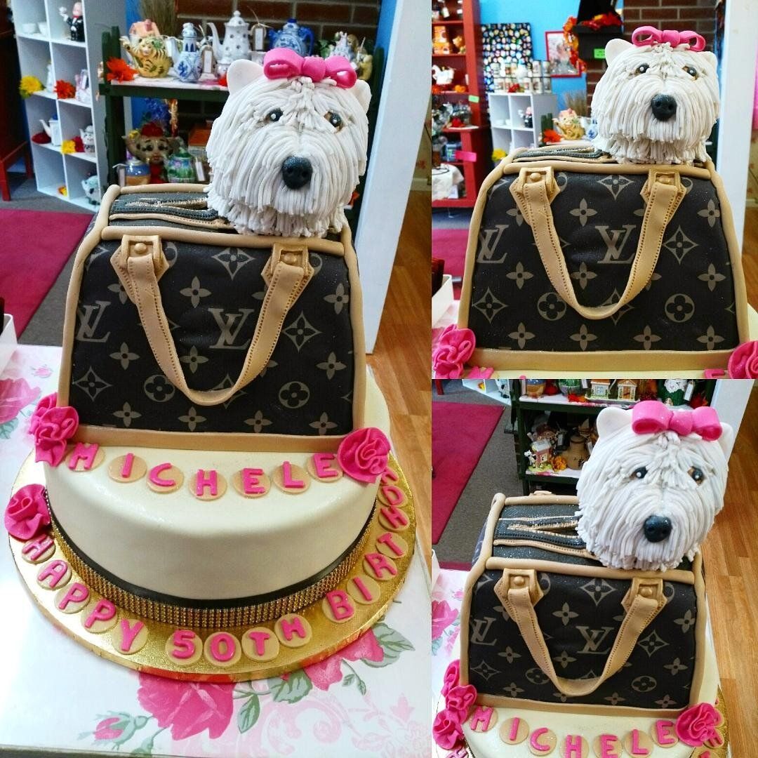A birthday cake with a dog in a louis vuitton bag